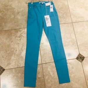 Celebrity Pink Teal mid rise skinny jeans.